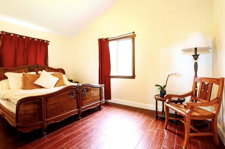 1001 Kauhikoa Road Haiku, HI 96708 - Photo 11 of 30 a bedroom with a bed and wooden floor