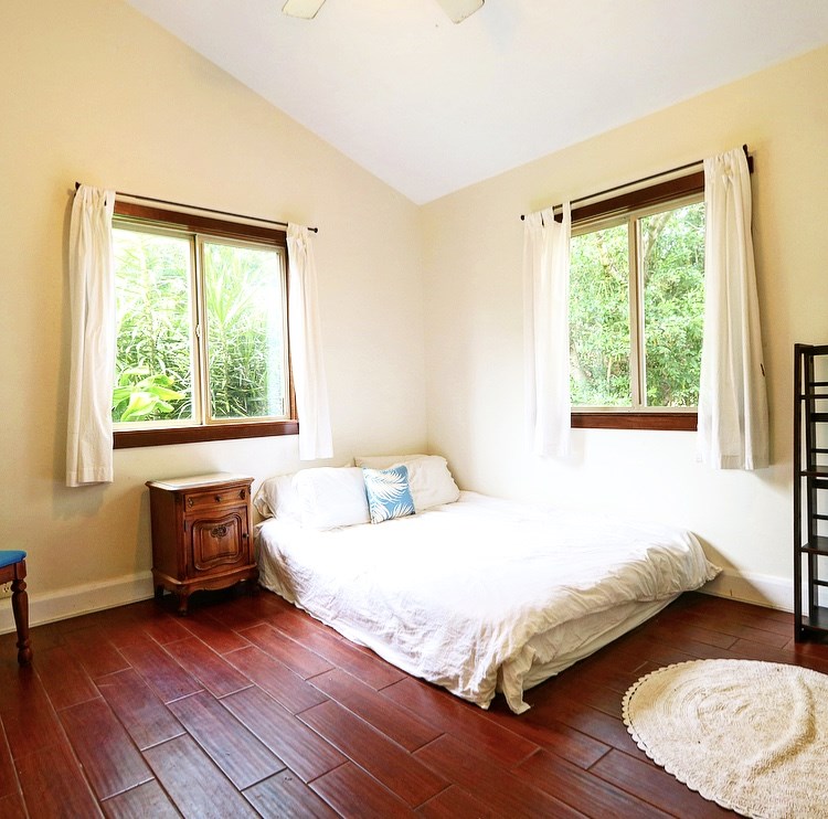 1001 Kauhikoa Road Haiku, HI 96708 - Photo 14 of 30 a bedroom with a bed and wooden floor