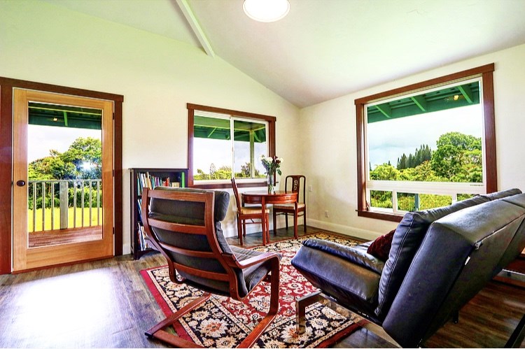 1001 Kauhikoa Road Haiku, HI 96708 - Photo 19 of 30 a living room with furniture and a floor to ceiling window