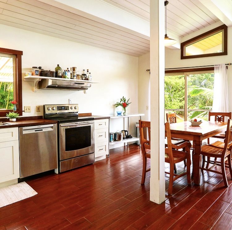 1001 Kauhikoa Road Haiku, HI 96708 - Photo 8 of 30 a kitchen with stainless steel appliances granite countertop wooden floors and table