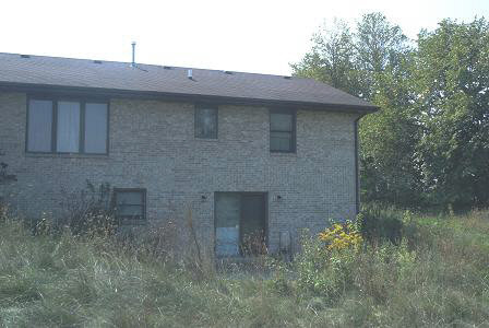 3998 East Whitaker Road Byron, IL 61010 - Photo 3 of 6 a brick house with a small yard