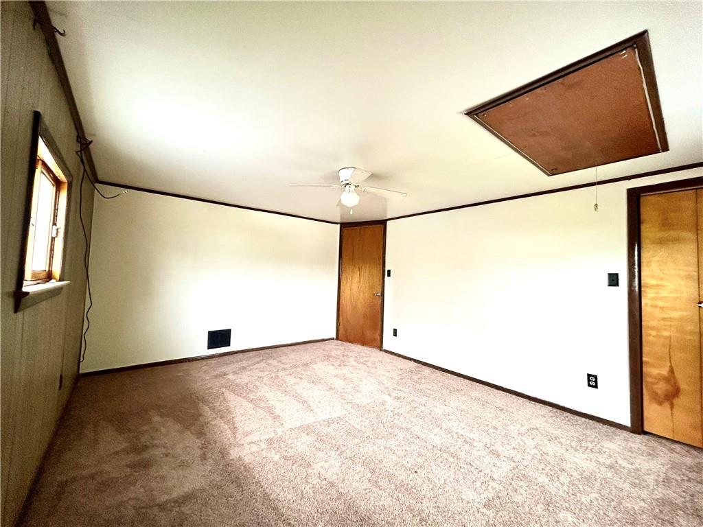 301 4th Street Allison, PA 15413 - Photo 17 of 29 an empty room with wooden floor and windows