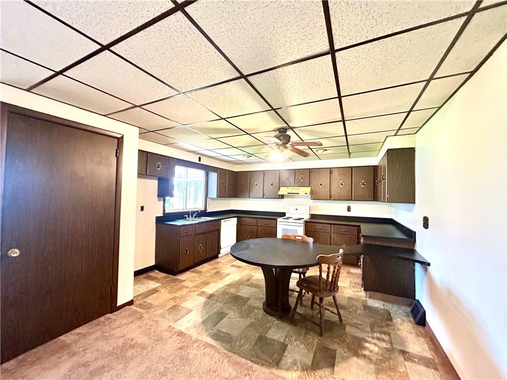 301 4th Street Allison, PA 15413 - Photo 2 of 29 a kitchen with a sink a counter and chairs