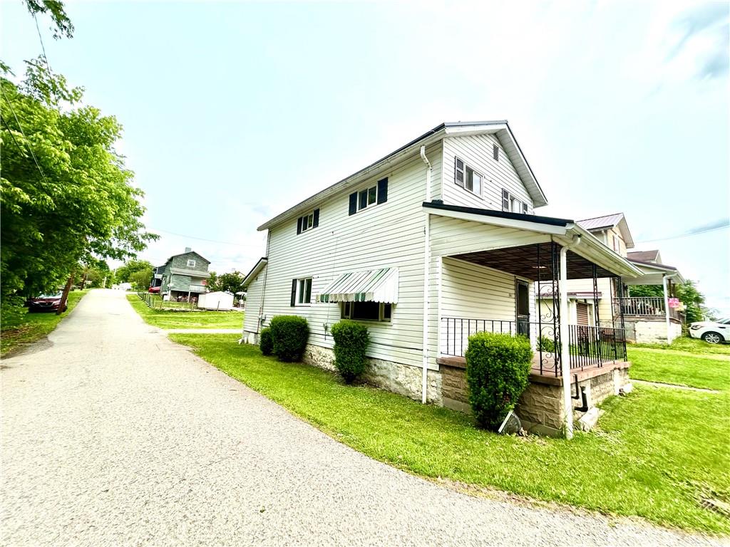 301 4th Street Allison, PA 15413 - Photo 27 of 29 a front view of a house with a yard table and chairs
