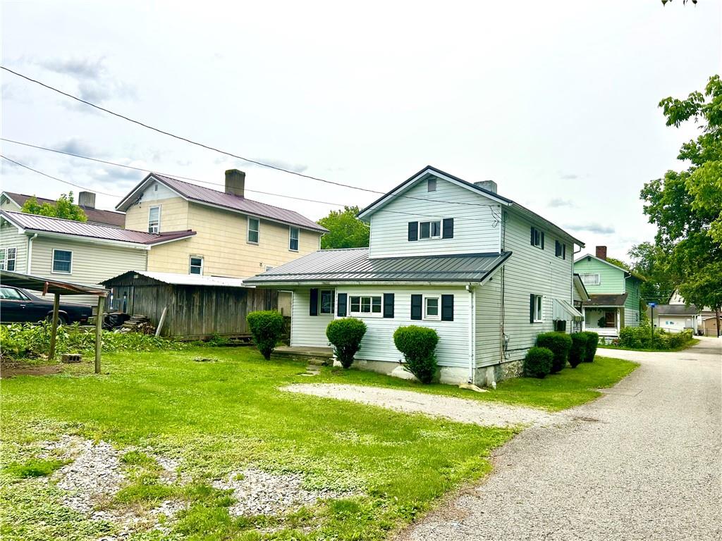 301 4th Street Allison, PA 15413 - Photo 28 of 29 a front view of a house with garden and plants