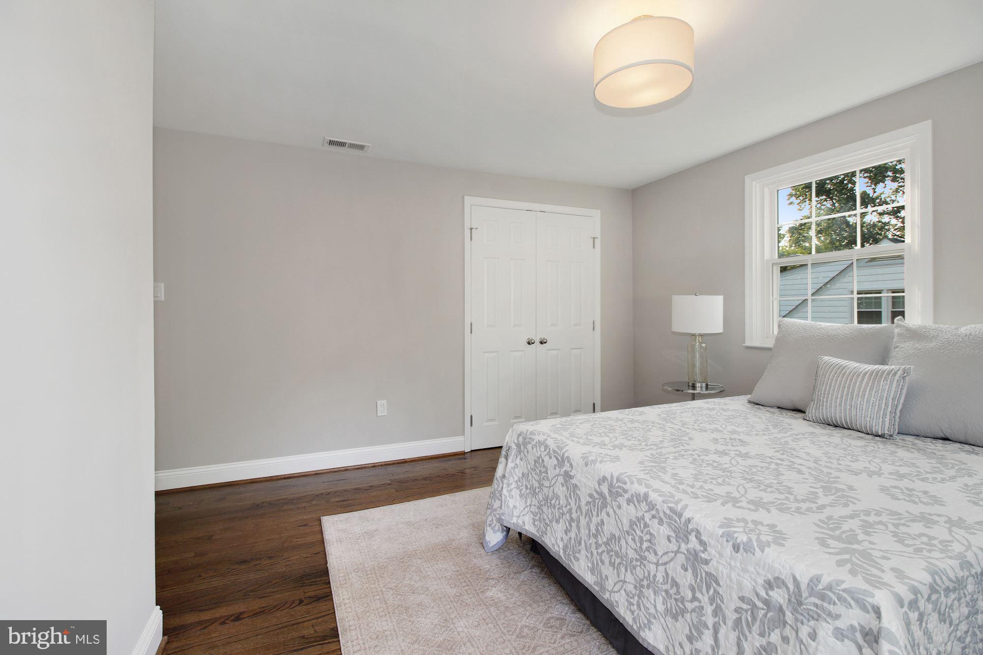 7003 Kenleigh Road Baltimore, MD 21212 - Photo 11 of 28 a bedroom with a bed and wooden floor
