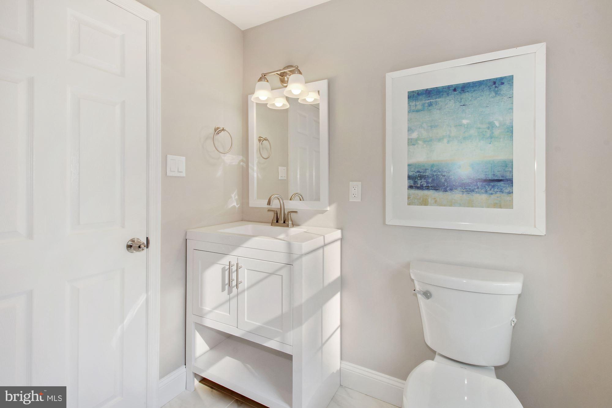 7003 Kenleigh Road Baltimore, MD 21212 - Photo 12 of 28 a bathroom with a toilet sink and mirror