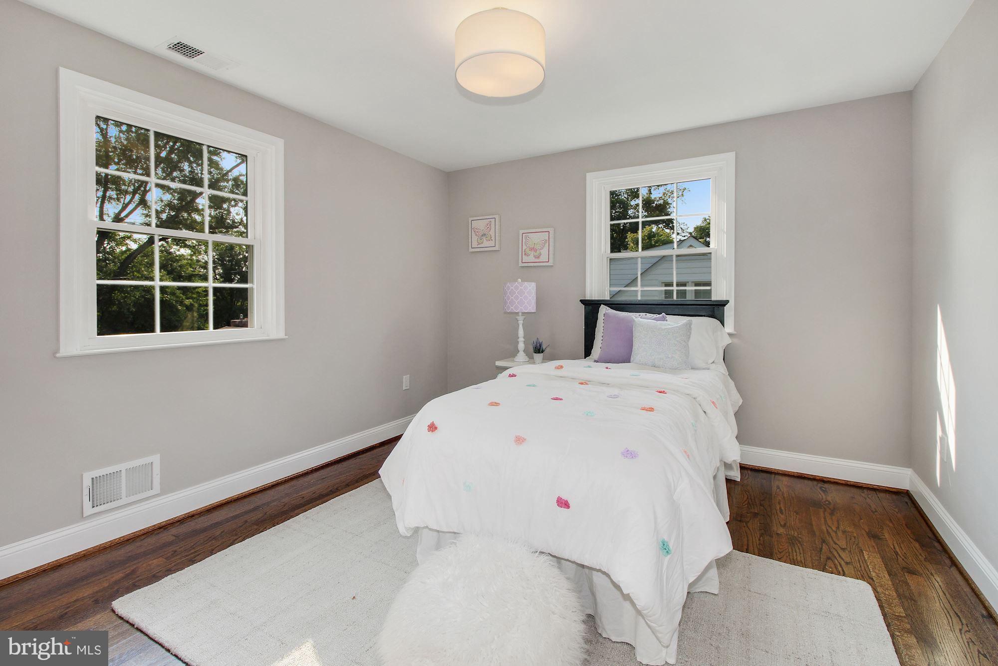 7003 Kenleigh Road Baltimore, MD 21212 - Photo 17 of 28 a view of a bedroom with wooden floor and window