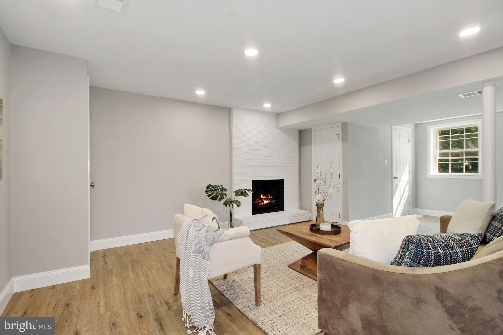 7003 Kenleigh Road Baltimore, MD 21212 - Photo 20 of 28 a living room with furniture a fireplace and a table