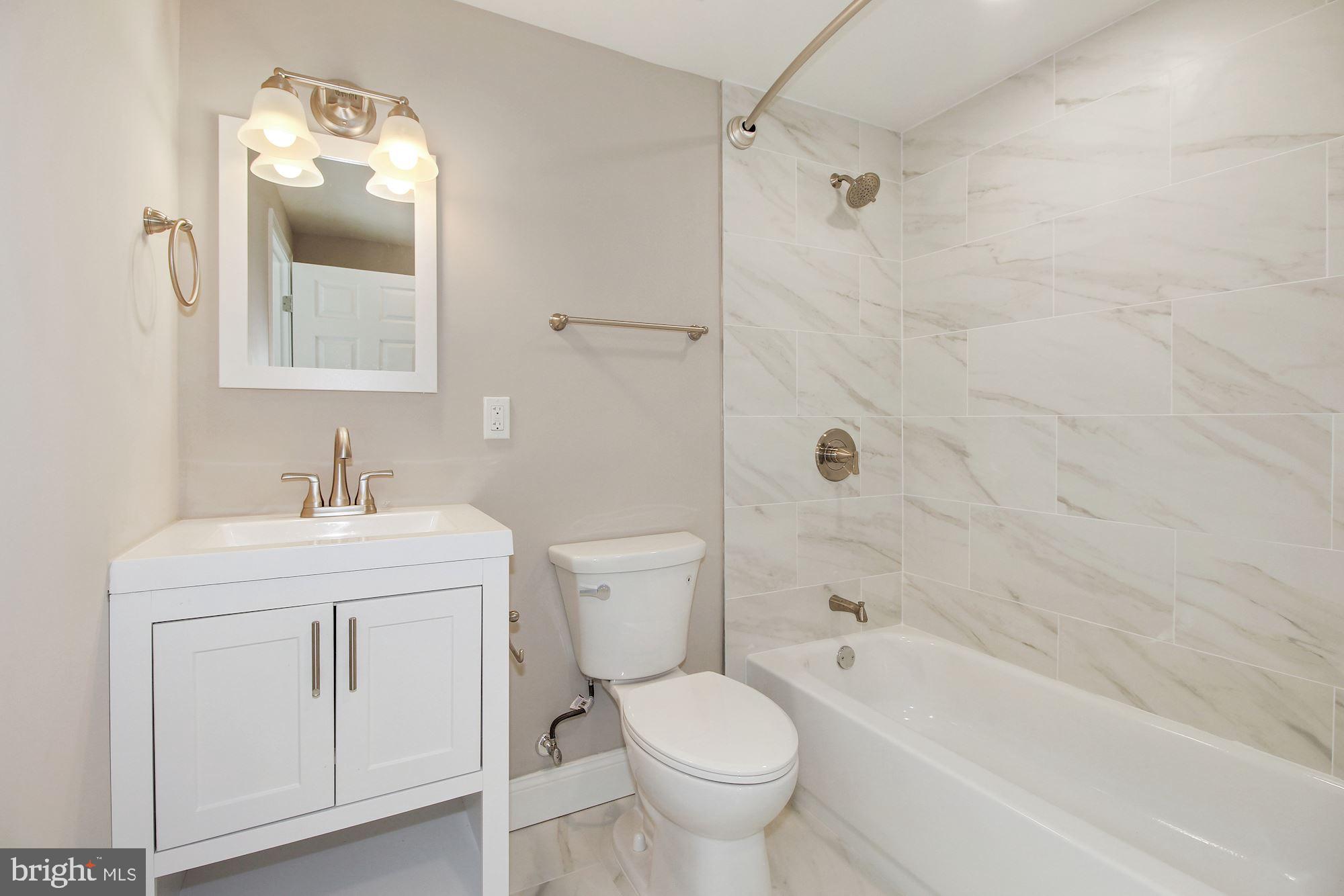 7003 Kenleigh Road Baltimore, MD 21212 - Photo 24 of 28 a bathroom with a sink toilet and shower