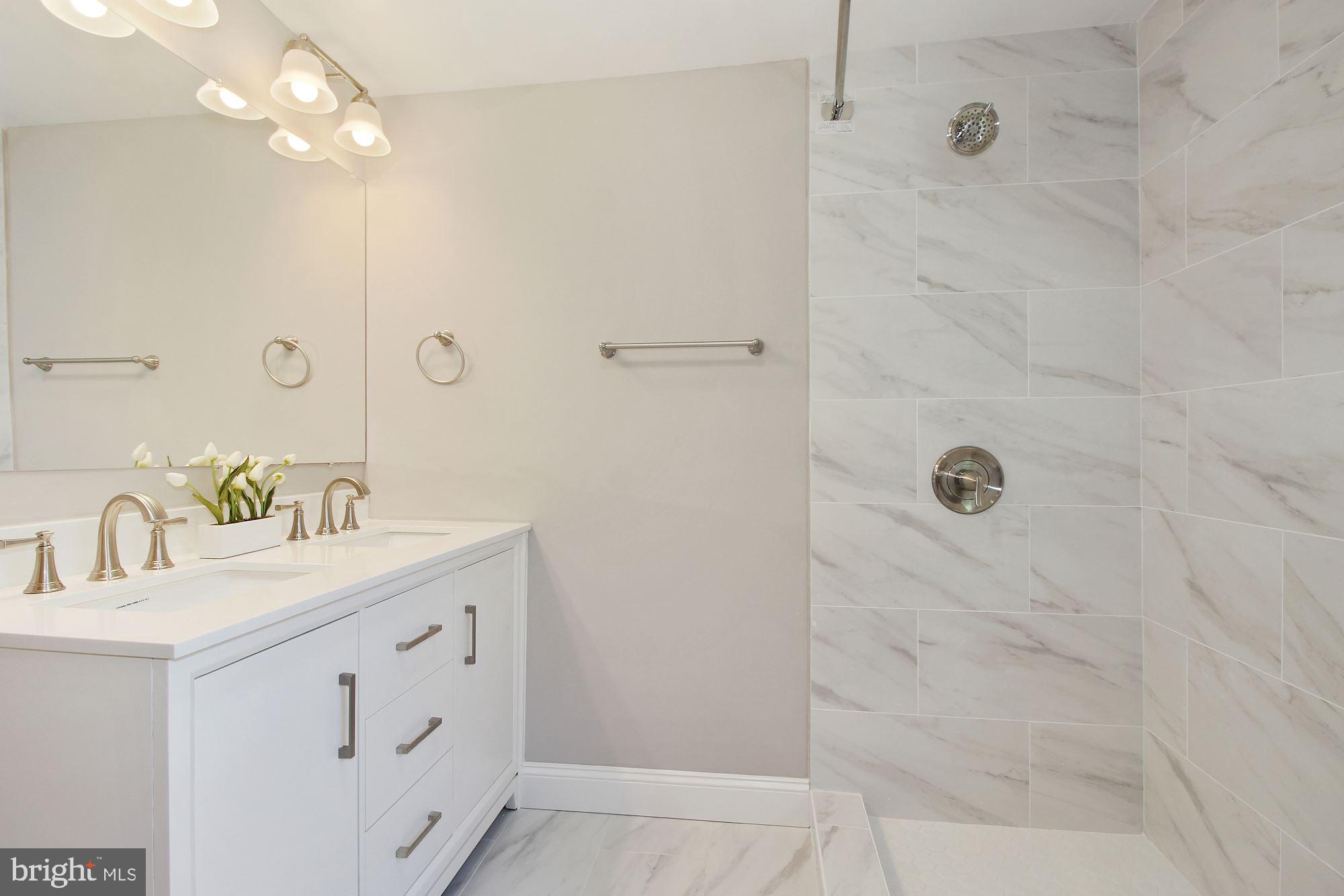 7003 Kenleigh Road Baltimore, MD 21212 - Photo 9 of 28 a bathroom with a double vanity sink a mirror and shower