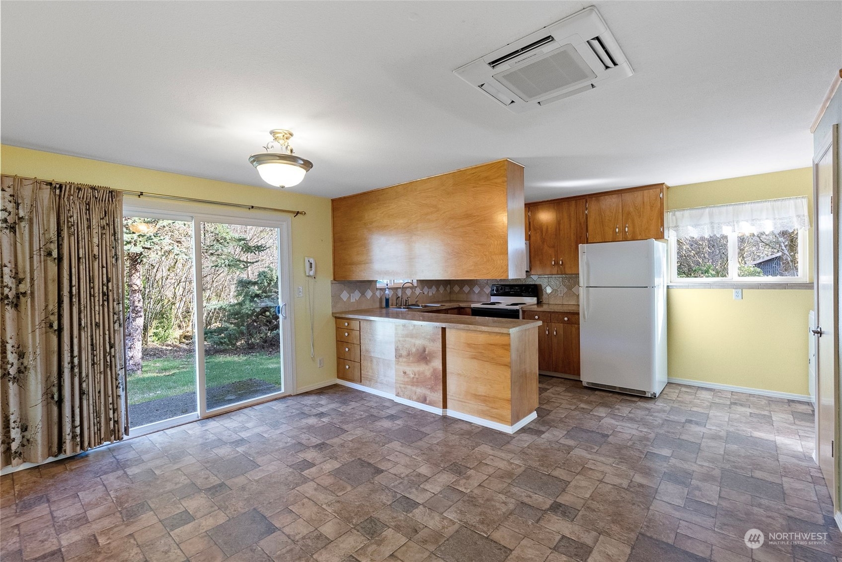 44223 Southeast Ernies Grove Road Snoqualmie, WA 98065 - Photo 9 of 21 a kitchen with a refrigerator and a stove top oven
