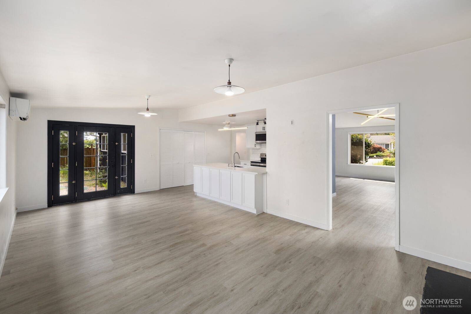 101 161st Street Southeast Bothell, WA 98012 - Photo 25 of 34 a view of a big room with wooden floor and a kitchen