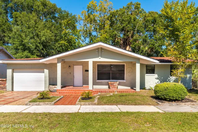 a backyard of a house with yard and outdoor seating
