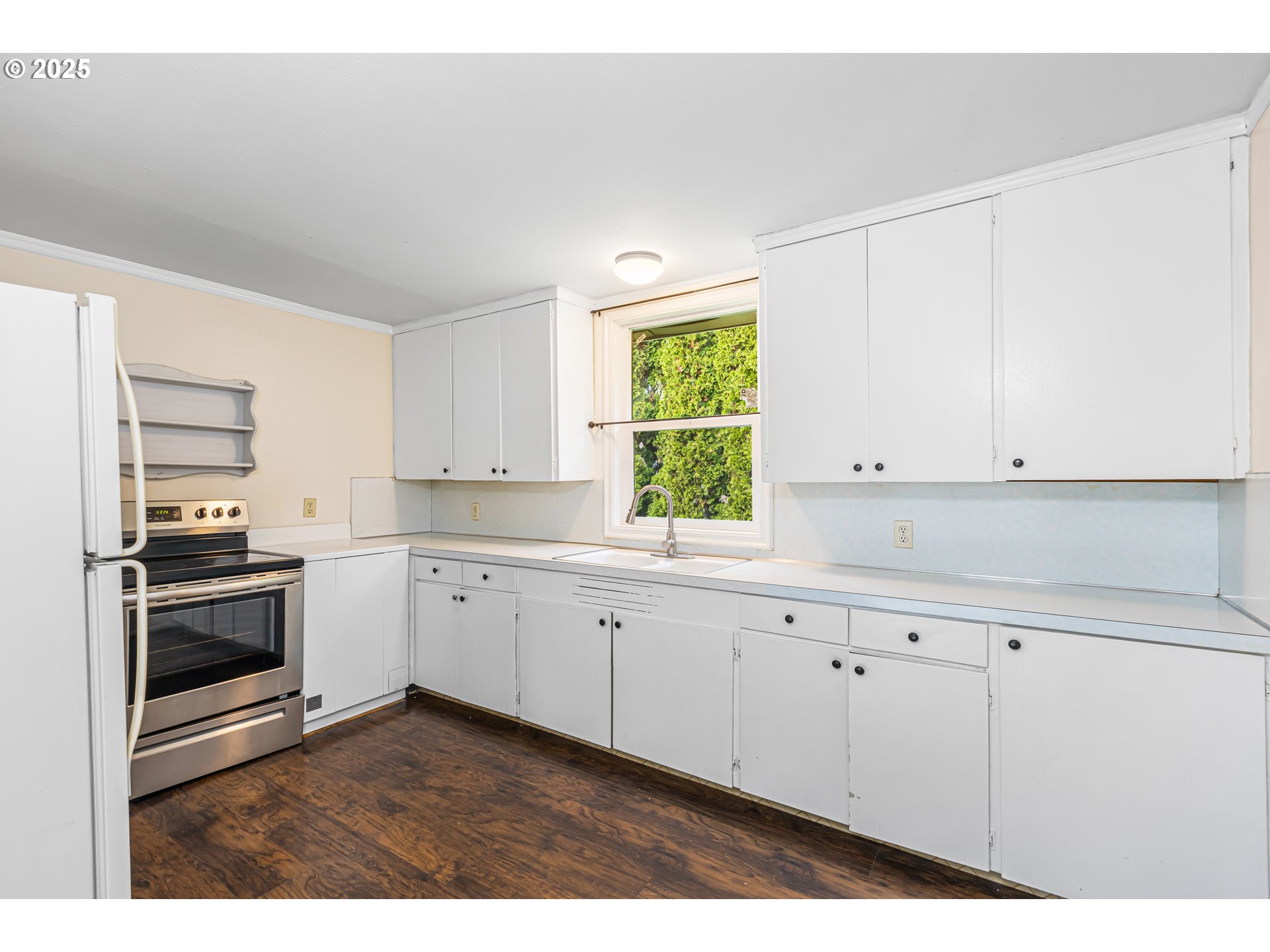 532 2nd Street Elkton, OR 97436 - Photo 13 of 32 a kitchen with granite countertop white cabinets and appliances