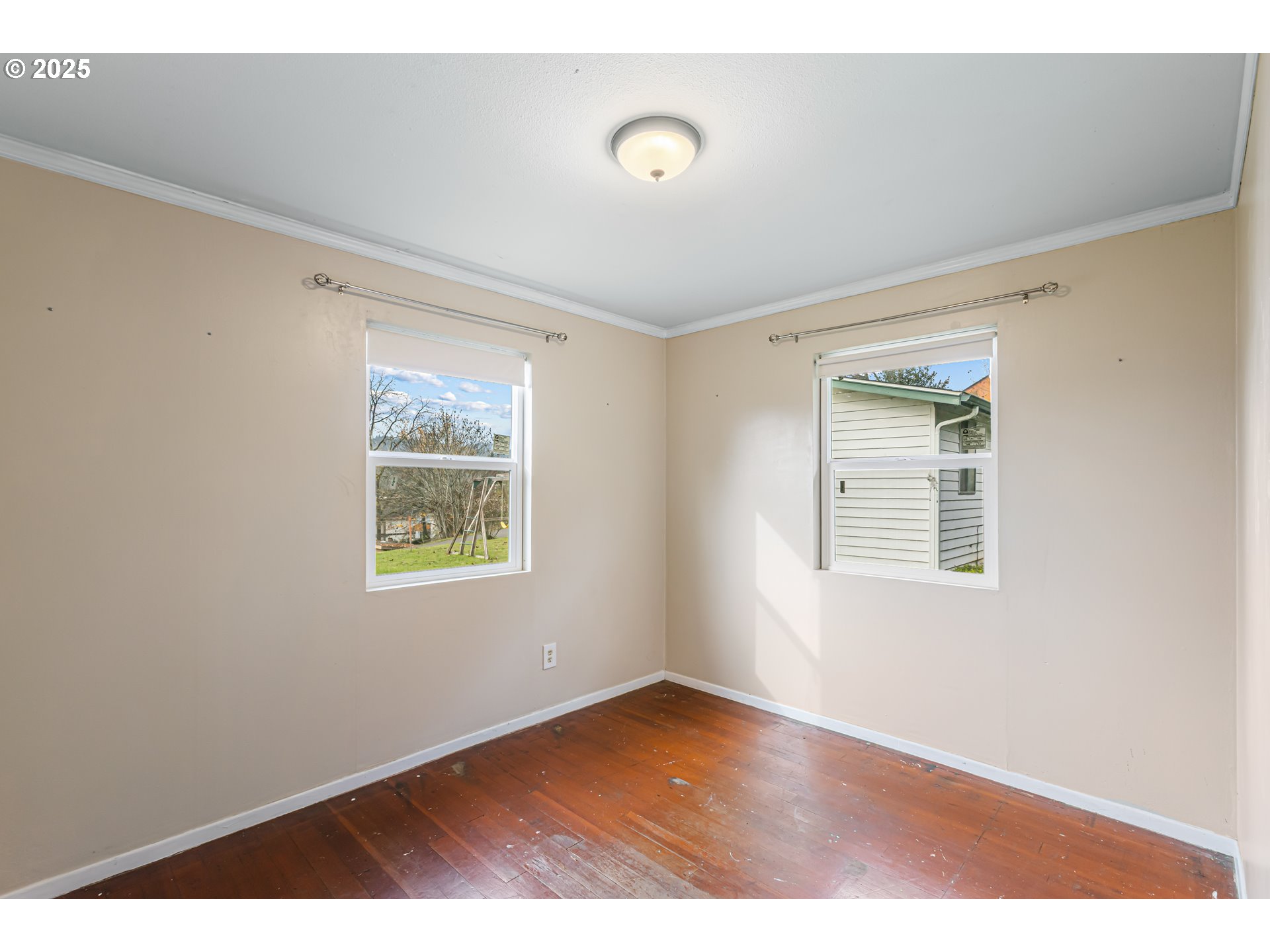 532 2nd Street Elkton, OR 97436 - Photo 24 of 32 a view of an empty room with wooden floor and a window