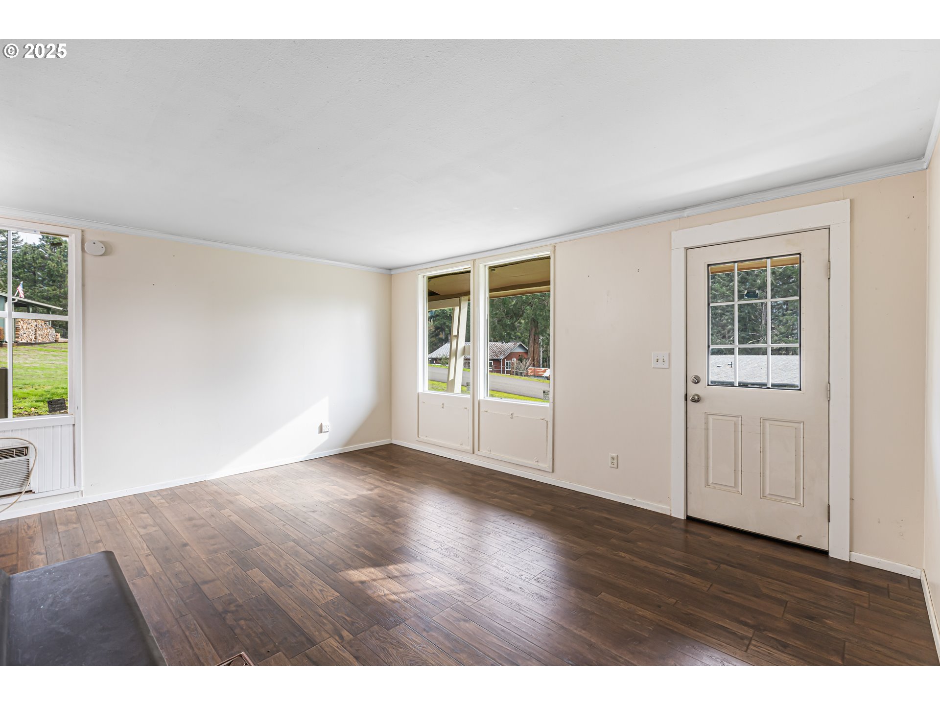532 2nd Street Elkton, OR 97436 - Photo 6 of 32 an empty room with wooden floor and windows