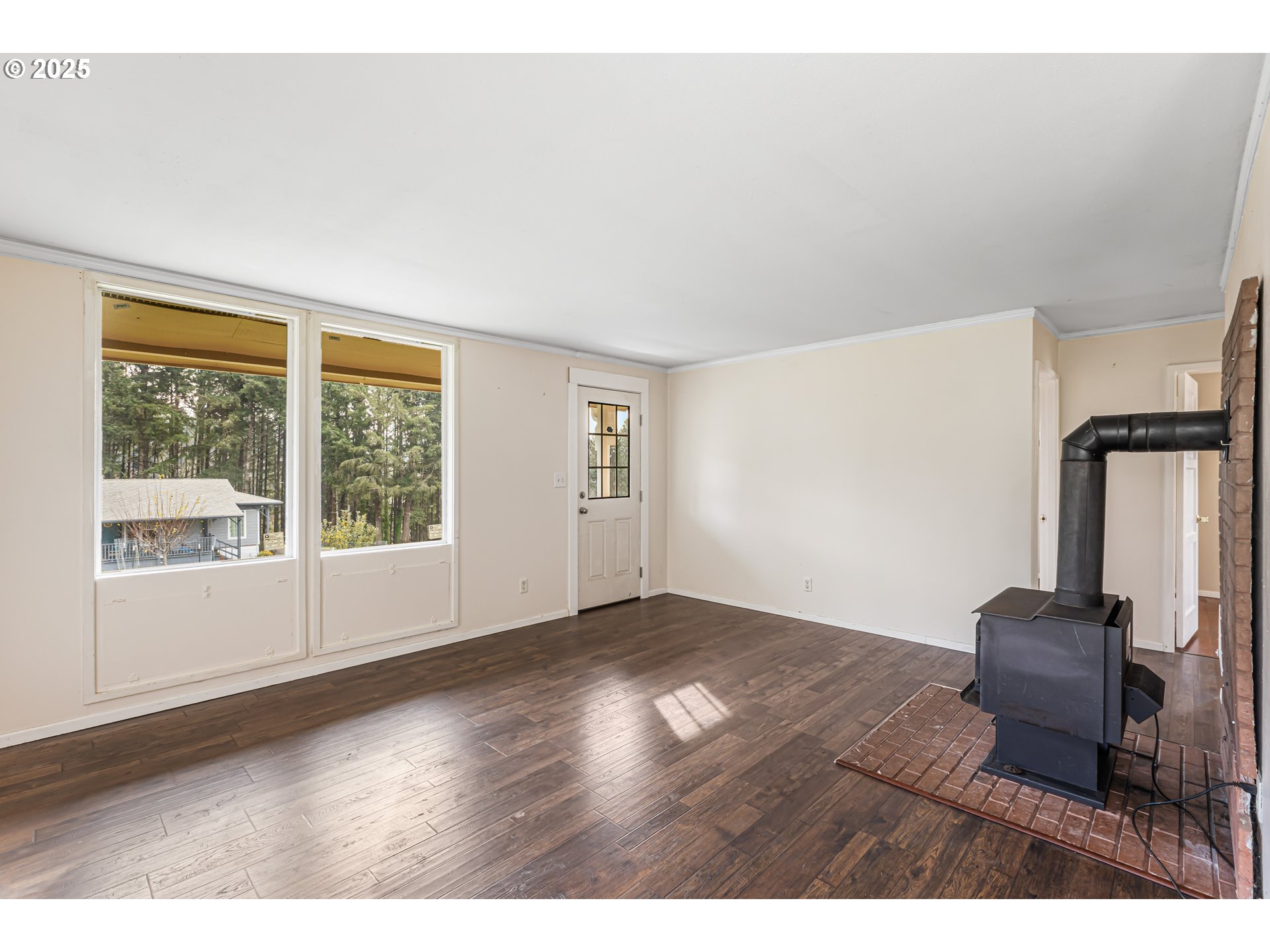 532 2nd Street Elkton, OR 97436 - Photo 8 of 32 a view of an empty room with wooden floor and a window