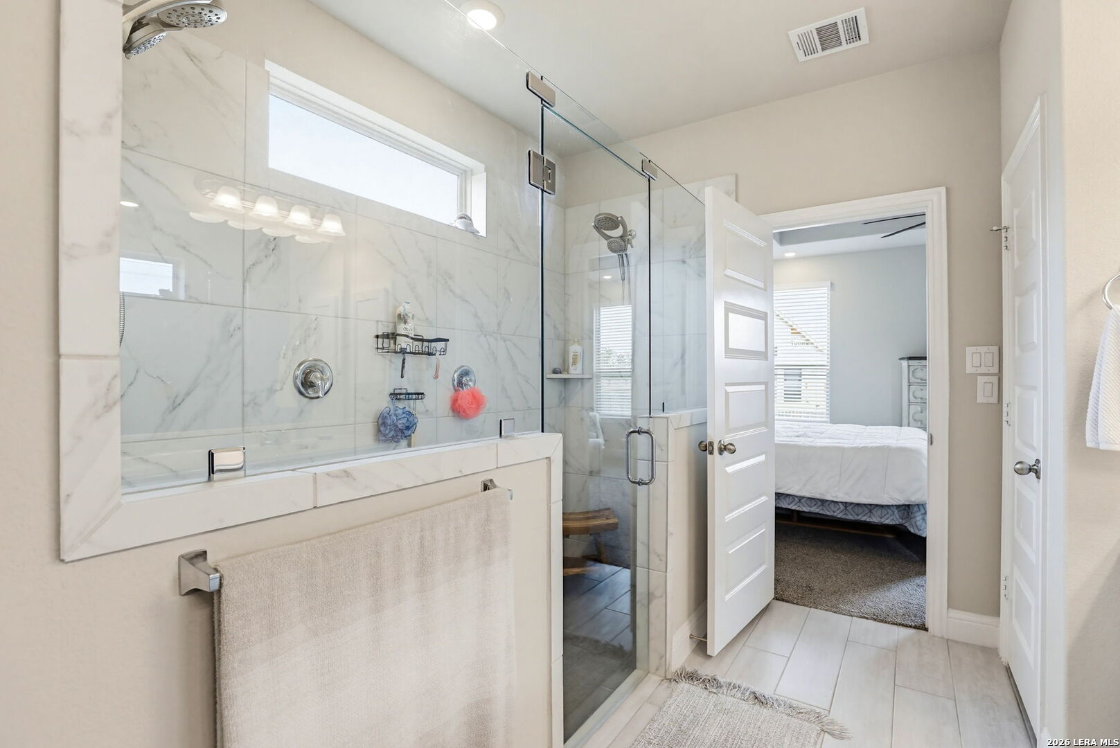 4174 Garden Path Marion, TX 78124 - Photo 12 of 21 a en suite bathroom with a sink a mirror and a shower