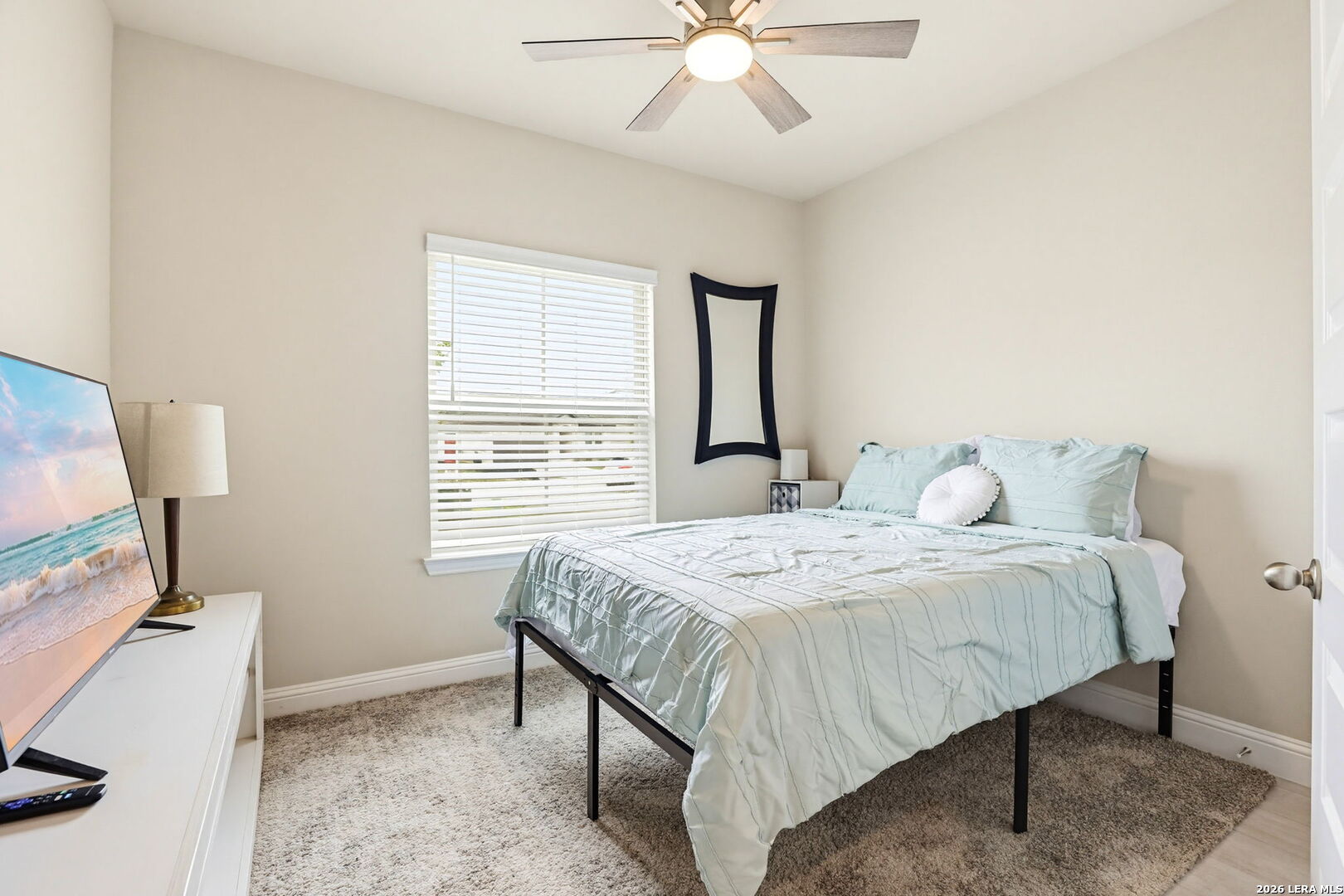 4174 Garden Path Marion, TX 78124 - Photo 17 of 21 a bedroom with a bed and a chandelier