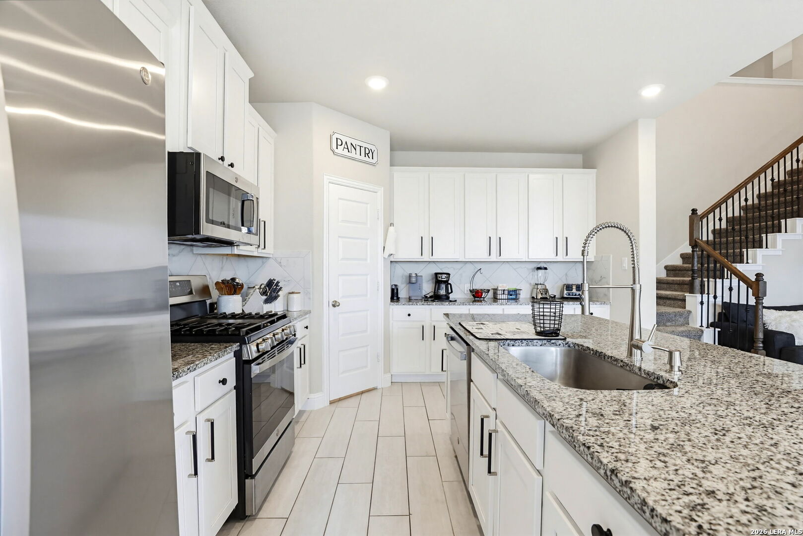 4174 Garden Path Marion, TX 78124 - Photo 5 of 21 a kitchen with granite countertop a sink stove and refrigerator