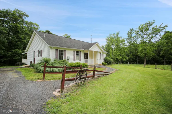 a view of a house with backyard and a sitting area