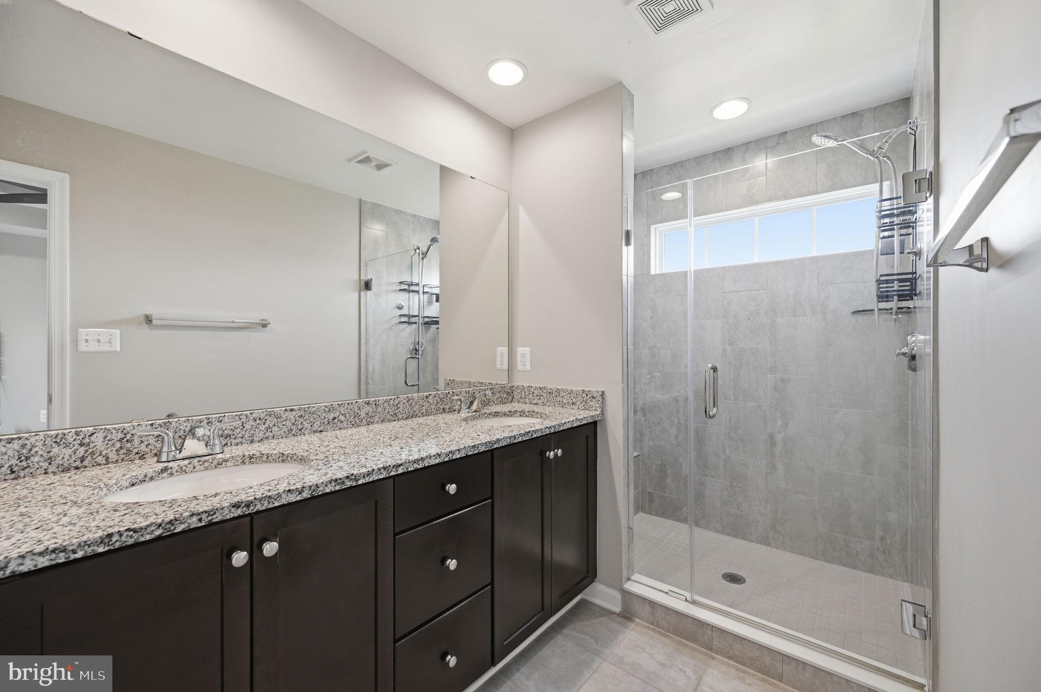 650 Aspen Road, Unit 108 Stafford, VA 22554 - Photo 12 of 26 Sleek modern bathroom with glass shower.