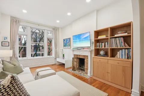 a living room with furniture a window and a fireplace