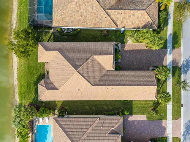 an aerial view of a house with a yard