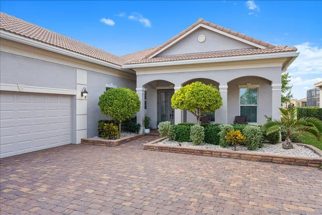 an aerial view of lake and residential houses with outdoor space