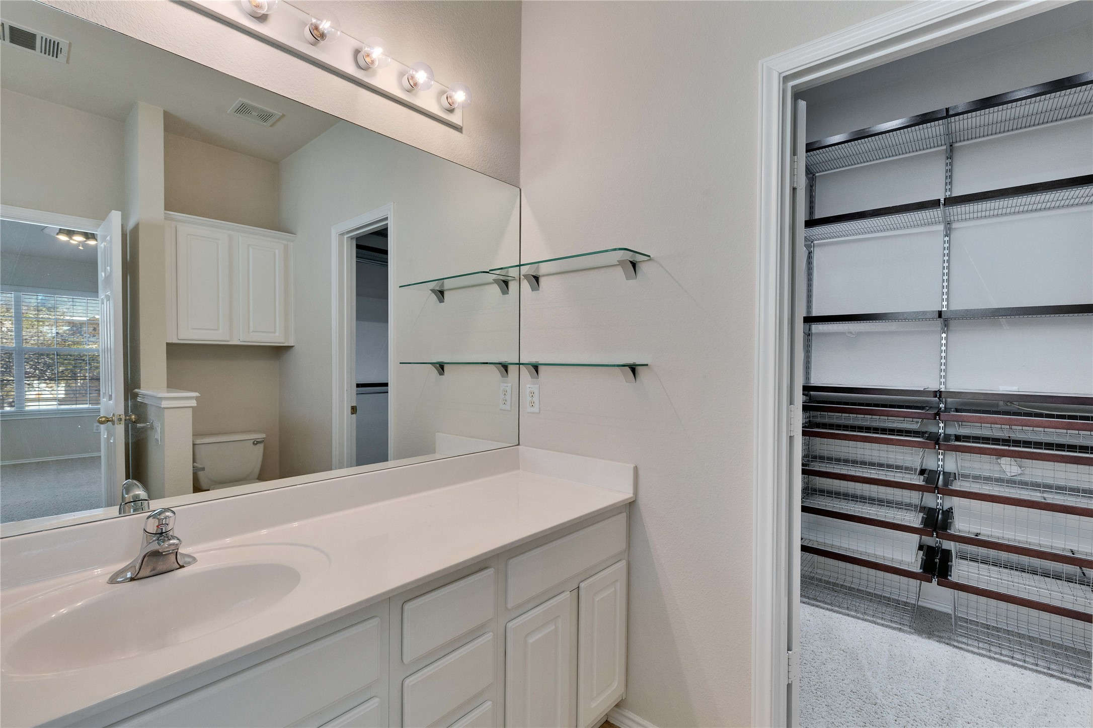 1900 Scofield Ridge Parkway, Unit 2701 Austin, TX 78727 - Photo 13 of 20 a bathroom with a sink and a mirror