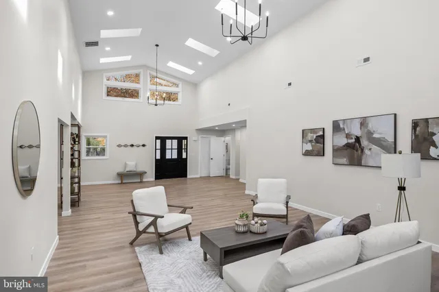 a living room with furniture and a chandelier