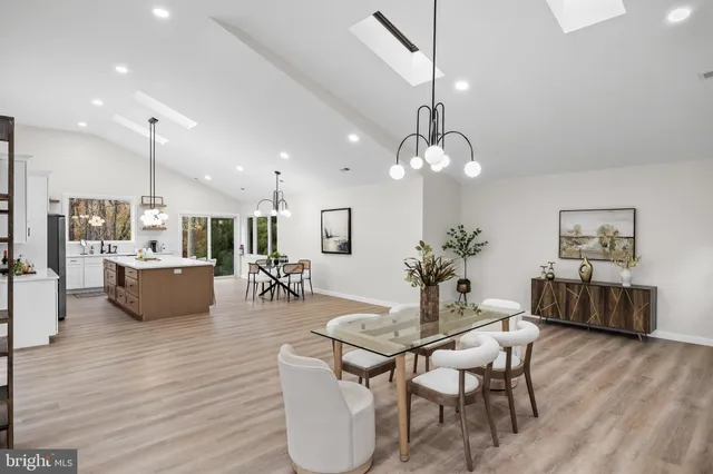 a view of a dining room with furniture wooden floor and chandelier