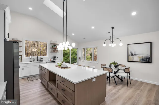 a kitchen with stainless steel appliances granite countertop a refrigerator sink and cabinets