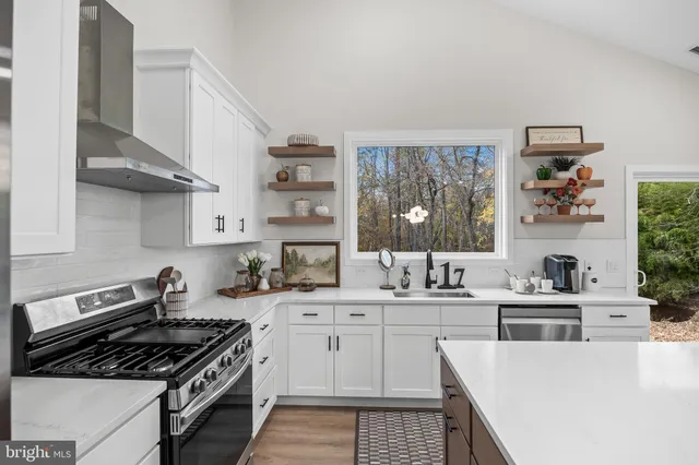 a kitchen with stainless steel appliances a sink stove and refrigerator