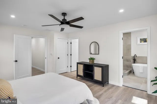 a spacious bathroom with a sink and a mirror
