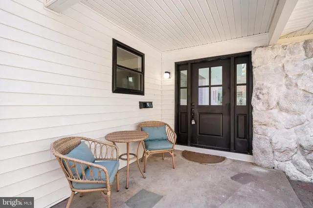 a balcony with table and chairs