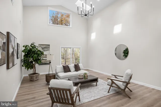 a living room with furniture and a chandelier