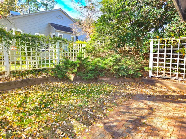 a view of a pathway of a house with a large tree