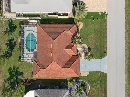 an aerial view of a house with a swimming pool