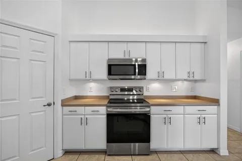 a kitchen with stainless steel appliances a sink stove and cabinets