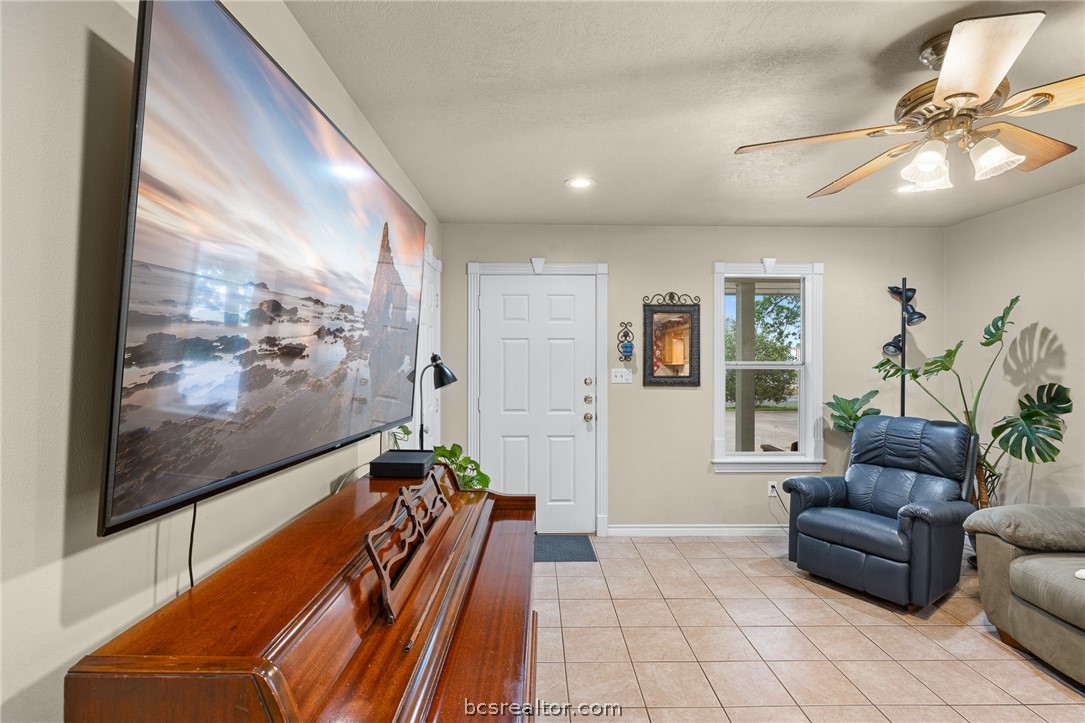 2287 North Earl Rudder Freeway Bryan, TX 77803 - Photo 30 of 32 a living room with furniture and a flat screen tv