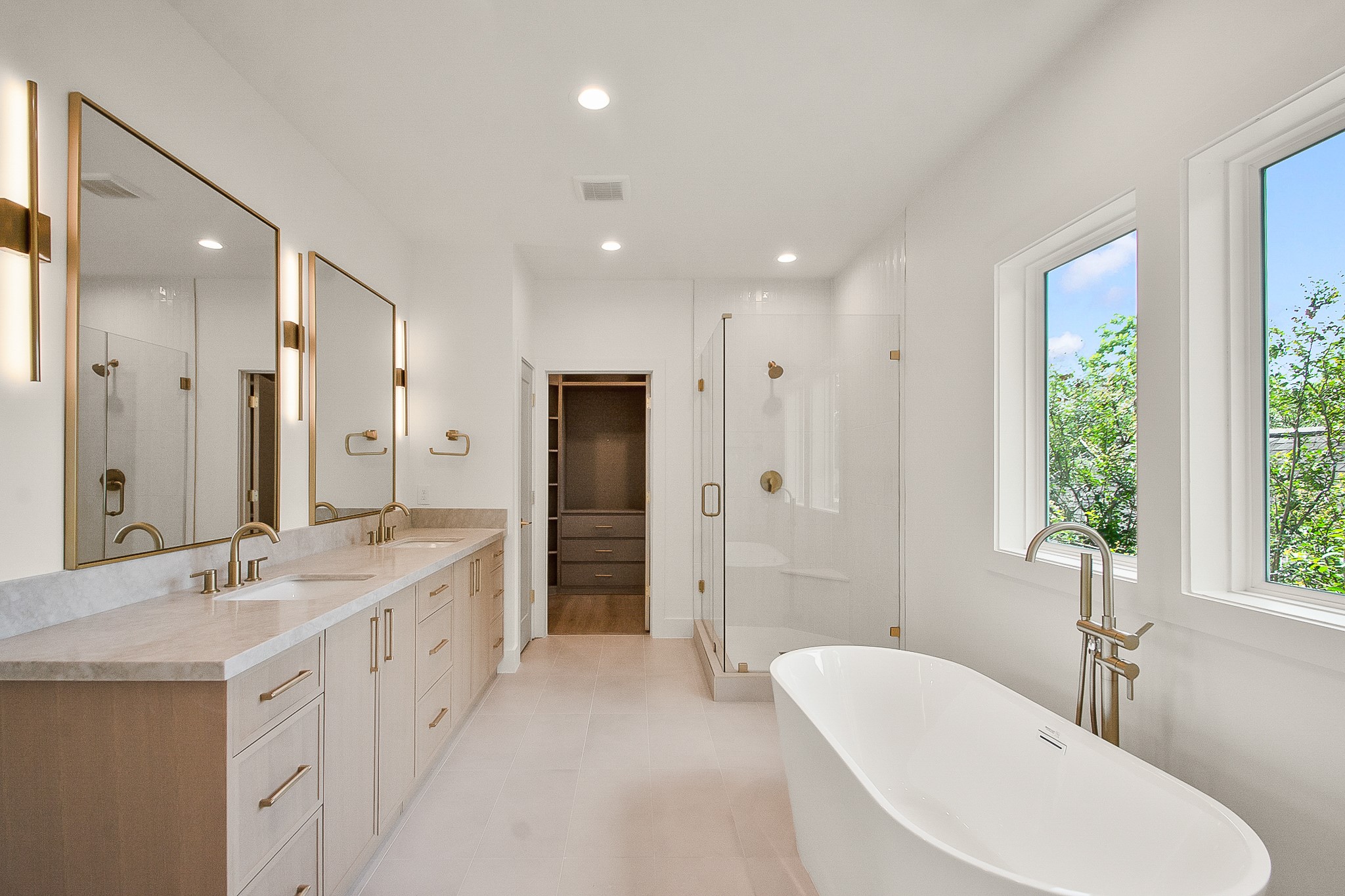 1109 Tabor Street Houston, TX 77009 - Photo 19 of 38 a spacious bathroom with a double vanity sink a large mirror and shower