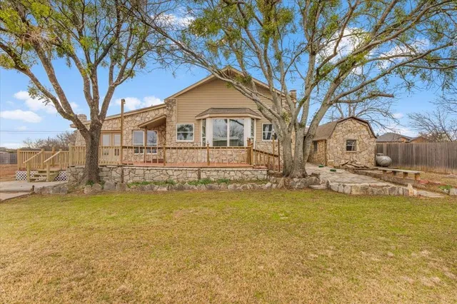 a front view of a house with swimming pool and a yard