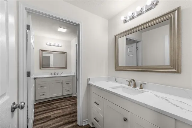 a bathroom with double vanity sink and a mirror