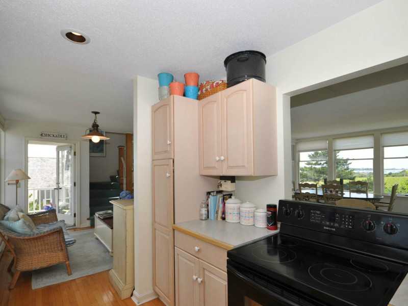 1714 Corn Neck Road, Unit 19 Block Island, RI 02807 - Photo 21 of 25 Kitchen. Opening in kitchen offers Great Salt Pond views while cooking