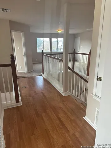 wooden floor in an empty room with a mirror