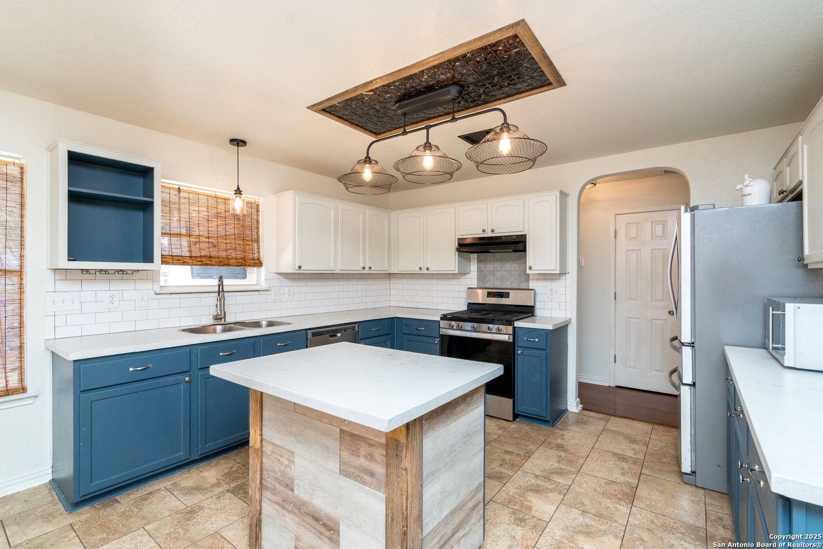 720 Fountain Gate Schertz, TX 78108 - Photo 14 of 34 a kitchen with stainless steel appliances granite countertop a sink a stove and a refrigerator
