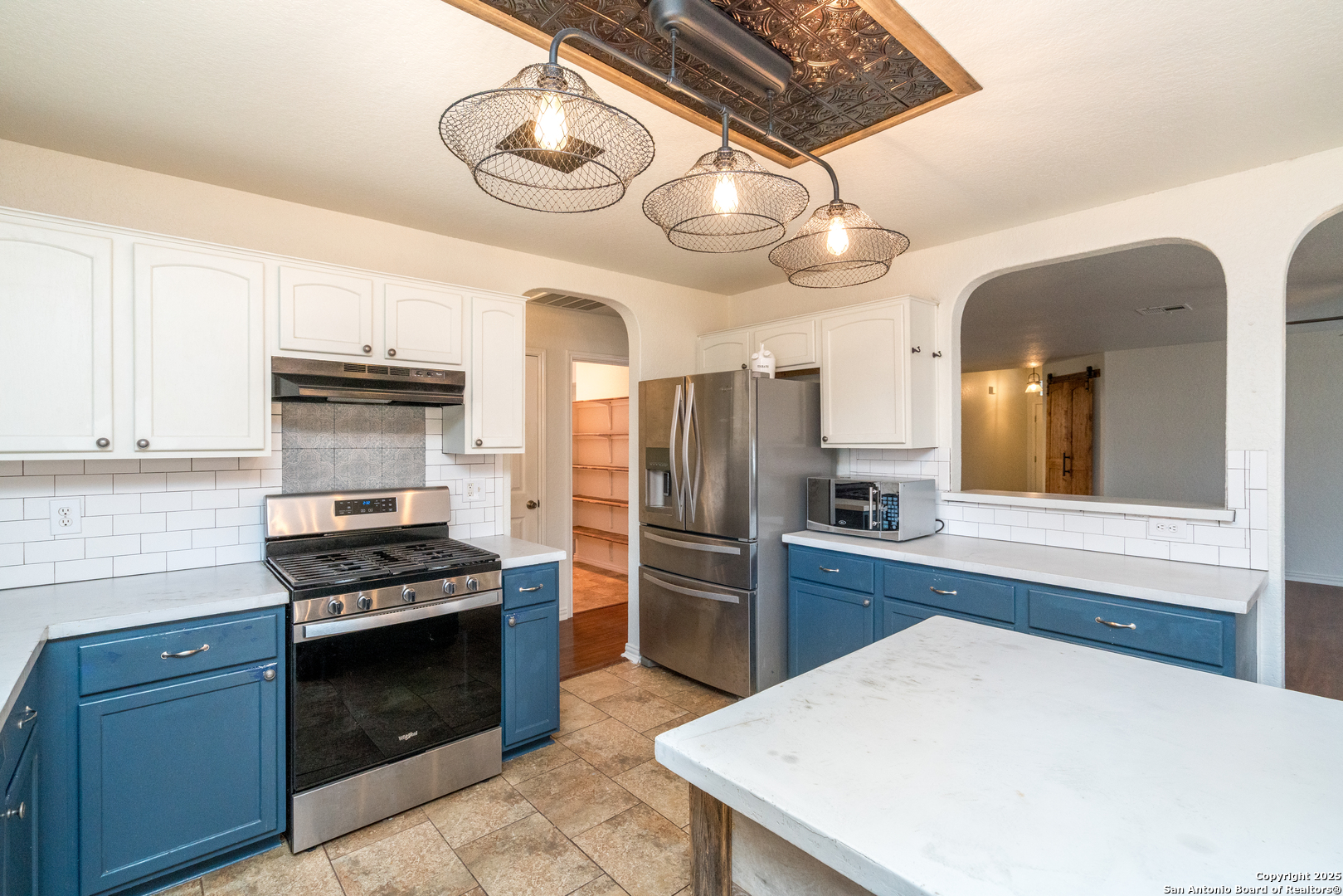 720 Fountain Gate Schertz, TX 78108 - Photo 17 of 34 a kitchen with a refrigerator a stove top oven and cabinets
