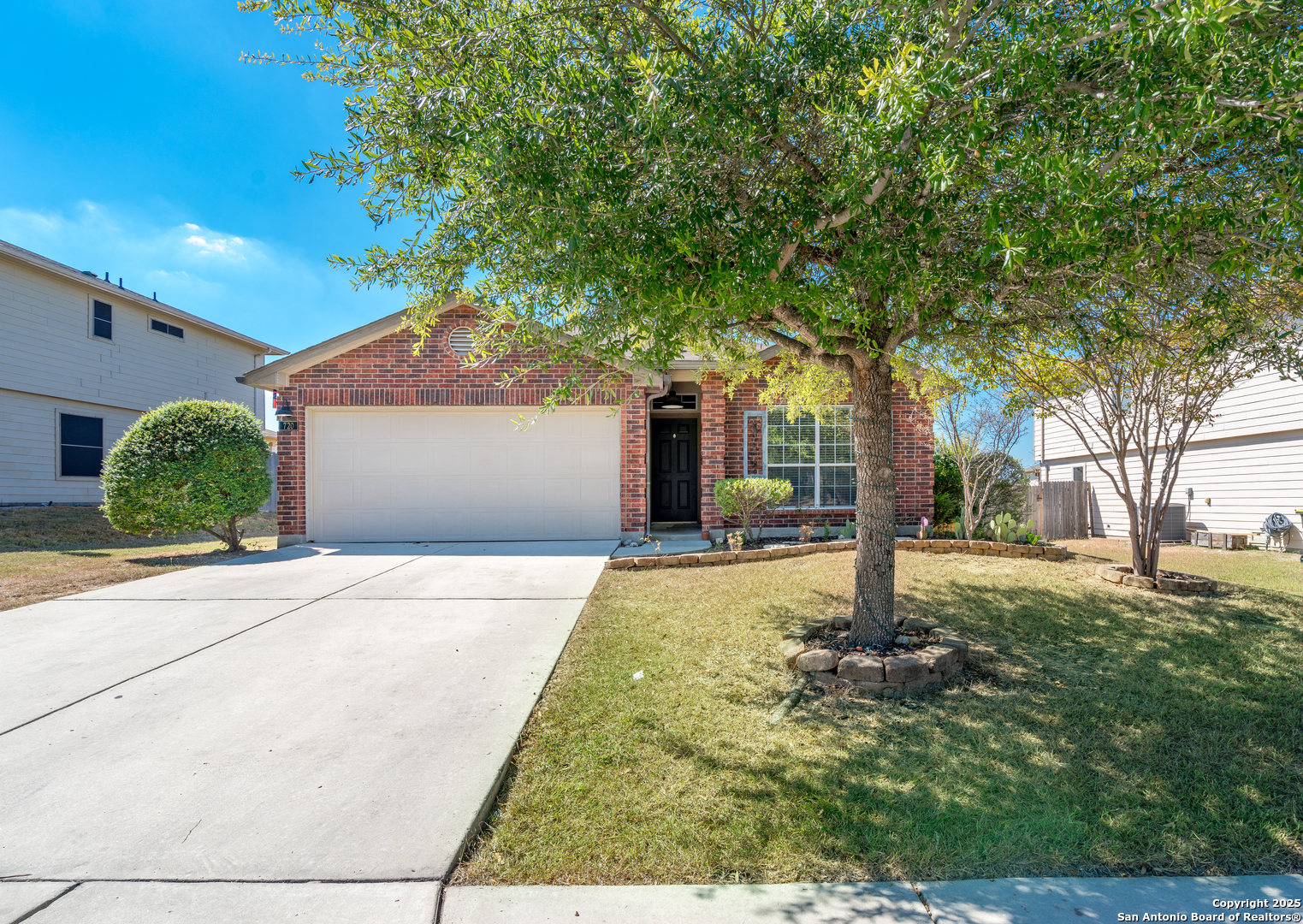 720 Fountain Gate Schertz, TX 78108 - Photo 2 of 34 a front view of a house with a yard and garage